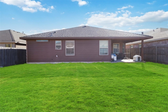 rear view of property featuring a lawn and a patio area