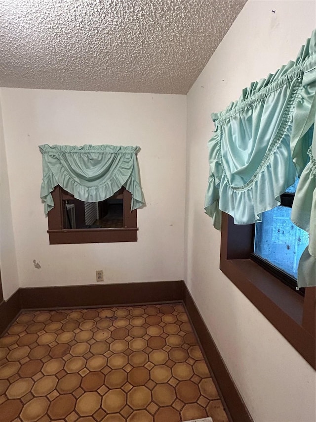 empty room featuring a textured ceiling