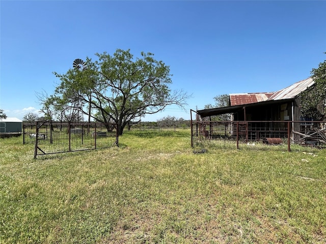 view of yard with an outdoor structure and a rural view