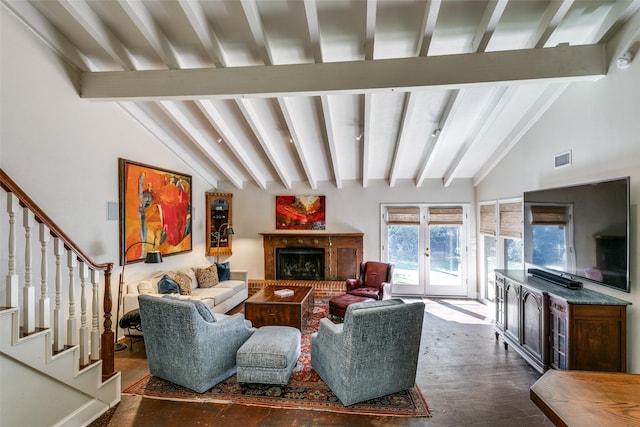 living room with french doors, dark hardwood / wood-style floors, lofted ceiling with beams, and a brick fireplace