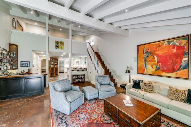 living room with beamed ceiling and bar