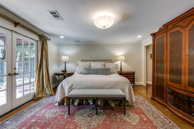 bedroom with crown molding, dark wood-type flooring, and french doors