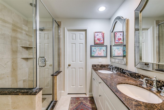 bathroom featuring walk in shower, vanity, and tile patterned flooring