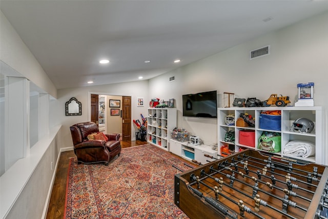 recreation room featuring hardwood / wood-style floors and vaulted ceiling