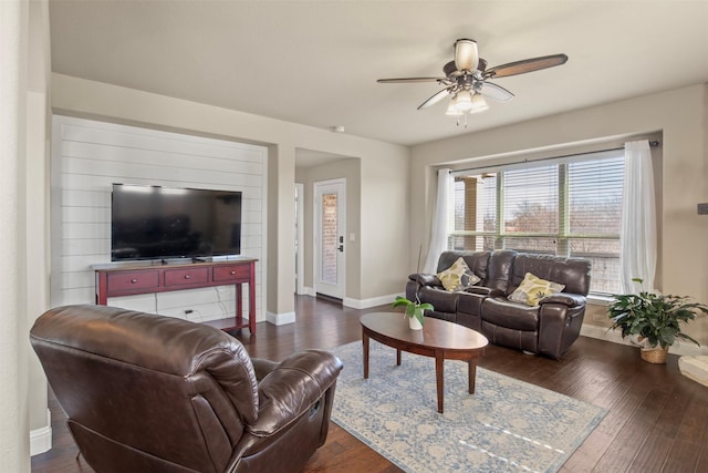 living room with dark wood-type flooring and ceiling fan