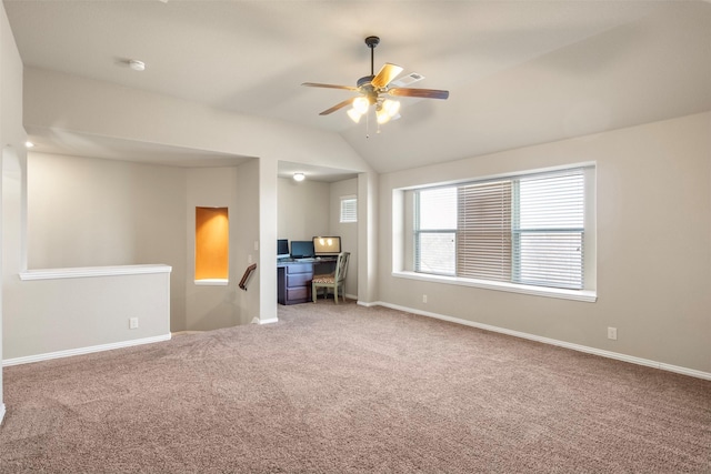 empty room featuring lofted ceiling, ceiling fan, and carpet