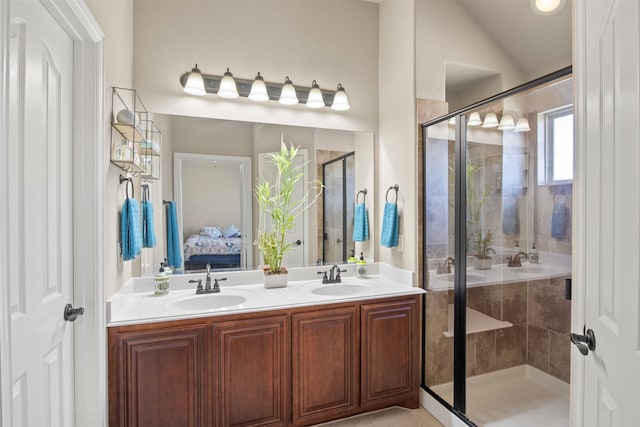 bathroom with vanity, vaulted ceiling, and a shower with shower door