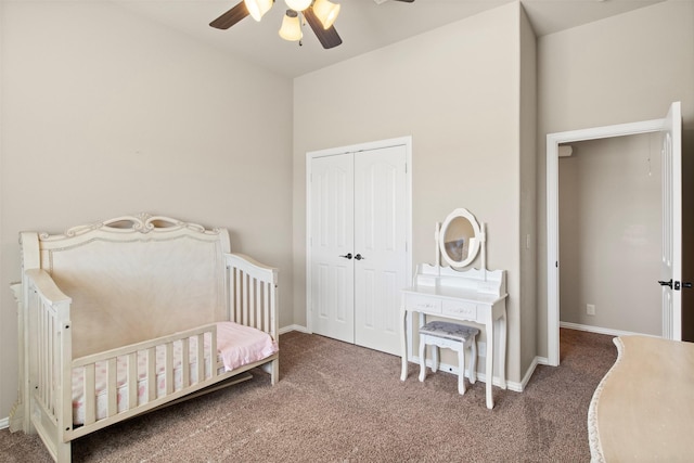 carpeted bedroom with ceiling fan and a closet