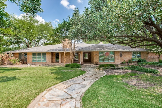 ranch-style home with a front lawn