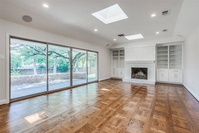 unfurnished living room featuring lofted ceiling with skylight, parquet floors, a fireplace, and built in shelves