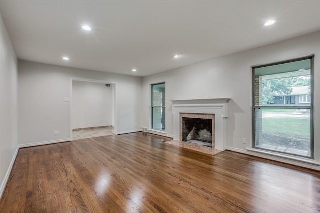 unfurnished living room featuring hardwood / wood-style flooring and a wealth of natural light