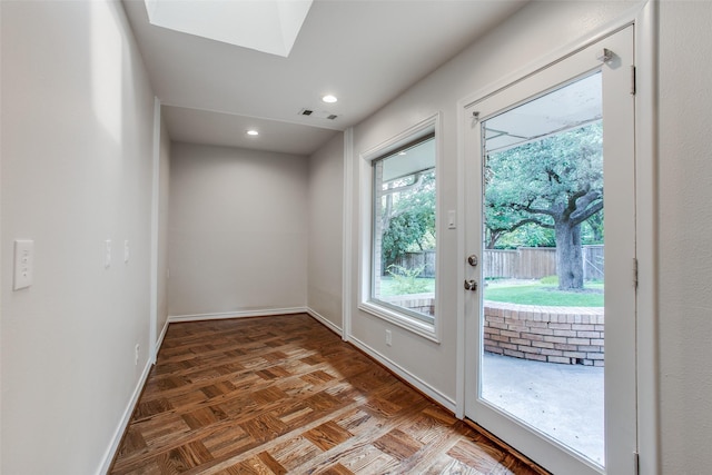 entryway featuring parquet flooring and a skylight