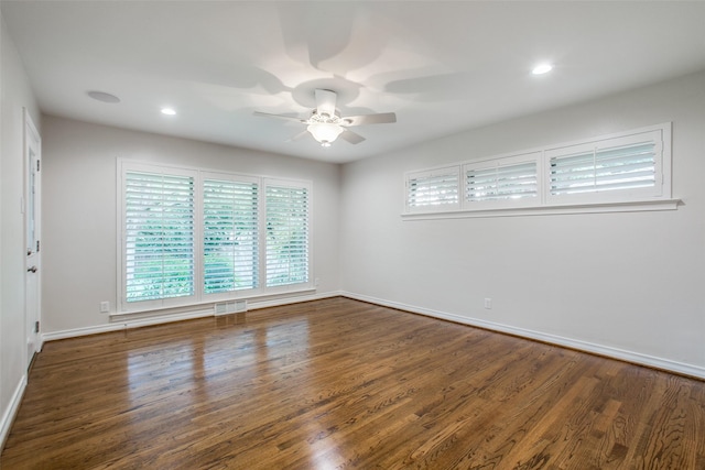 spare room with dark wood-type flooring and ceiling fan