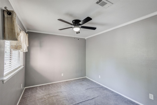 carpeted empty room featuring ceiling fan and ornamental molding