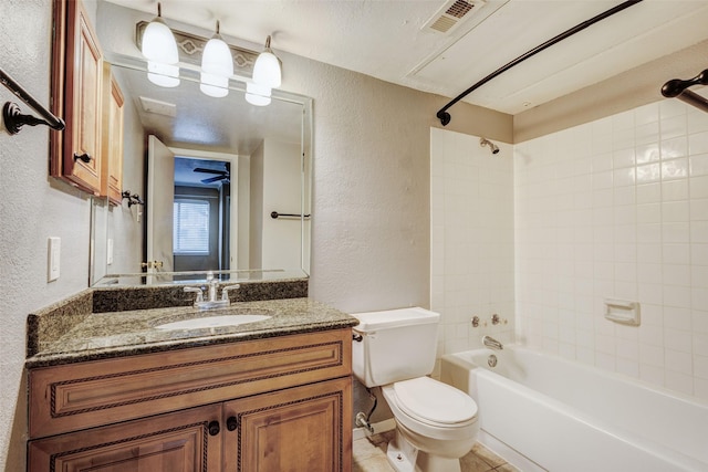 full bathroom with tiled shower / bath, vanity, toilet, and tile patterned flooring