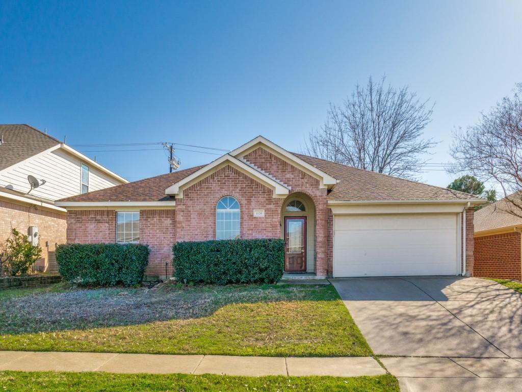 single story home featuring a garage and a front yard