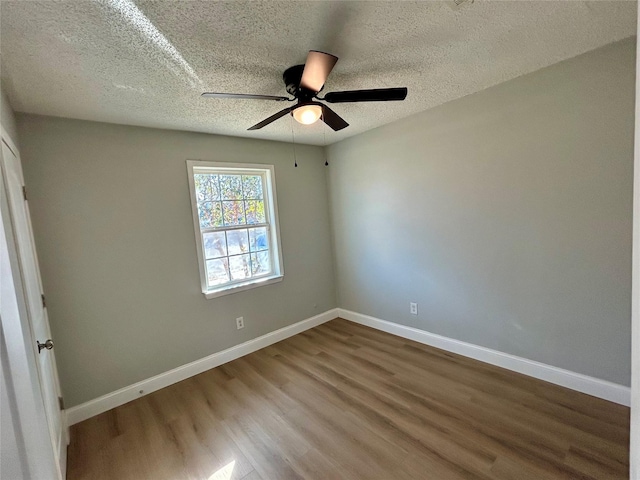 empty room featuring wood-type flooring, ceiling fan, and a textured ceiling