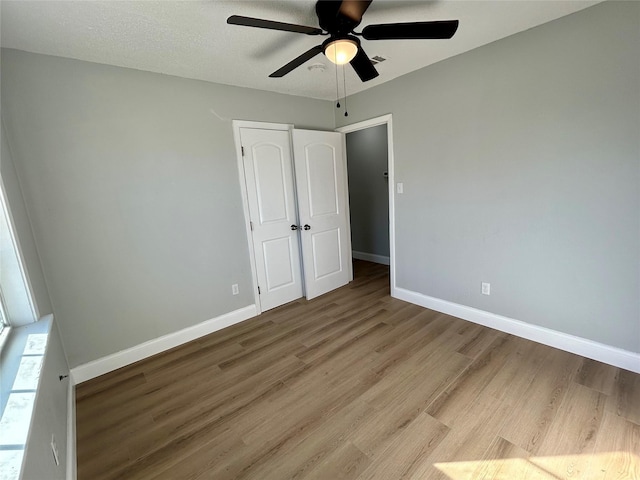 unfurnished bedroom featuring light hardwood / wood-style floors and ceiling fan