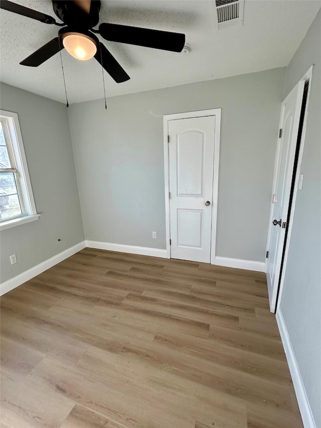 unfurnished room featuring ceiling fan and light hardwood / wood-style floors