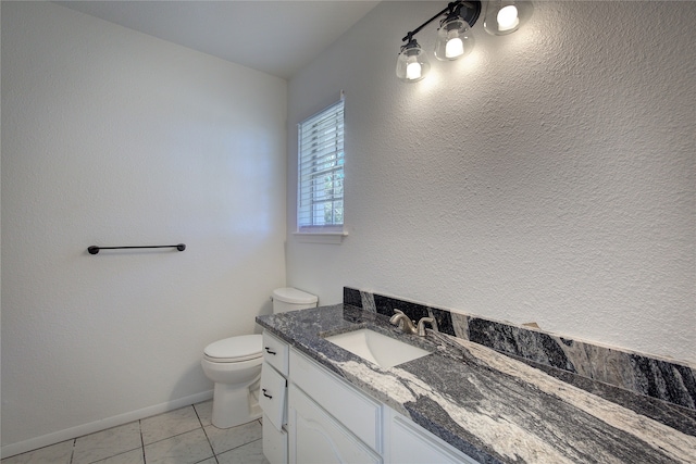 bathroom featuring vanity, tile patterned floors, and toilet