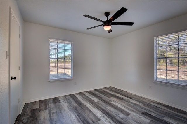 spare room with dark wood-type flooring and ceiling fan