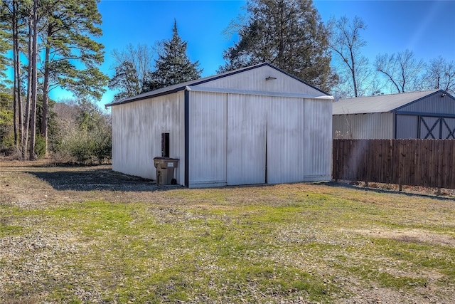 view of outbuilding featuring a yard