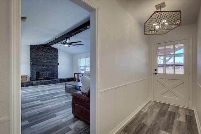 entryway with ceiling fan, a fireplace, dark hardwood / wood-style flooring, and vaulted ceiling with beams