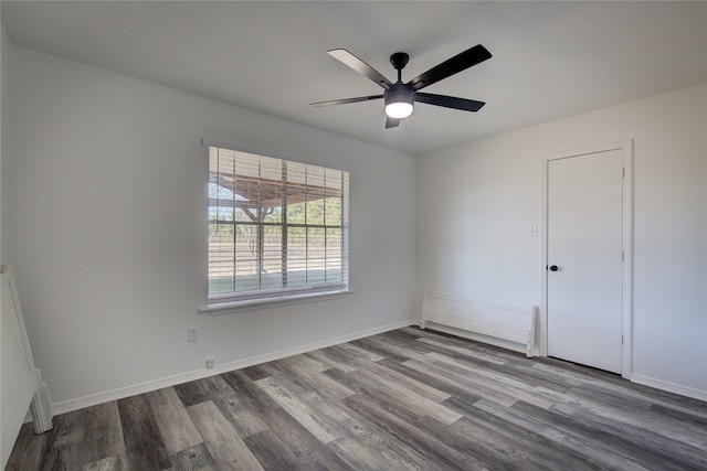 spare room with hardwood / wood-style flooring and ceiling fan