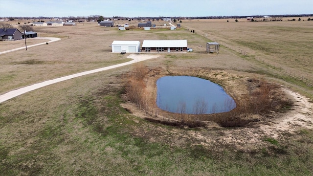 drone / aerial view with a water view and a rural view