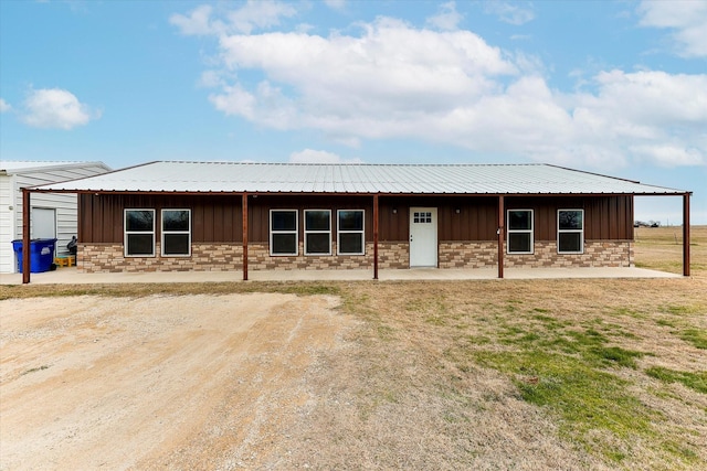 rear view of property with an outbuilding