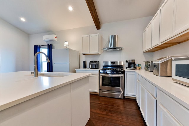 kitchen featuring white cabinetry, wall chimney range hood, white appliances, and sink