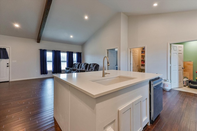 kitchen featuring dark wood-type flooring, sink, an island with sink, and white cabinets