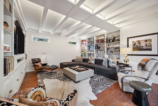 living room featuring brick floor, visible vents, and beamed ceiling