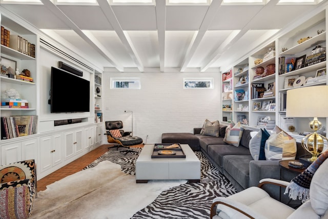 living room with built in features and beamed ceiling