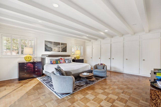 bedroom featuring multiple windows and beam ceiling