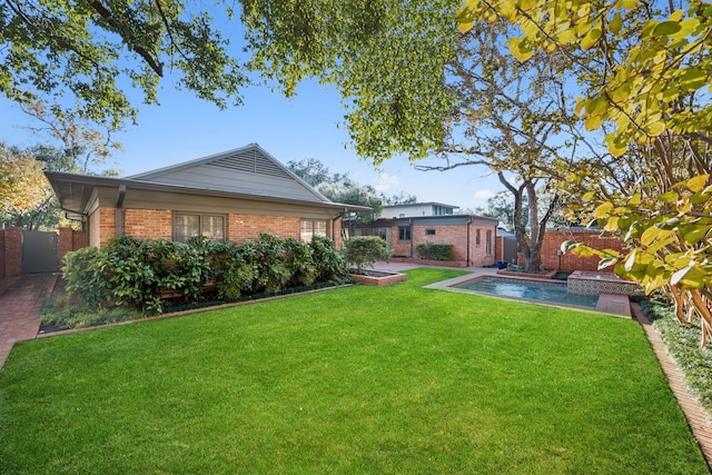 view of yard with a fenced in pool