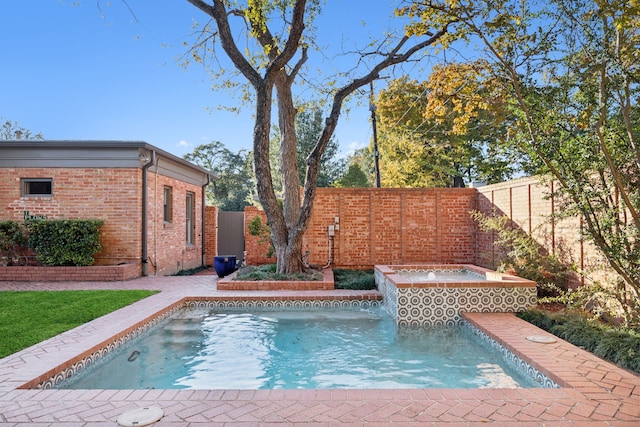 view of swimming pool featuring an in ground hot tub