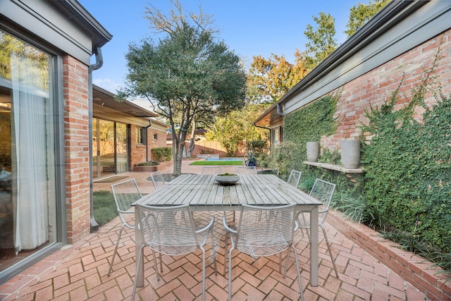 view of patio with outdoor dining area and fence