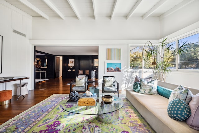 living room featuring beamed ceiling, wooden walls, and dark hardwood / wood-style floors