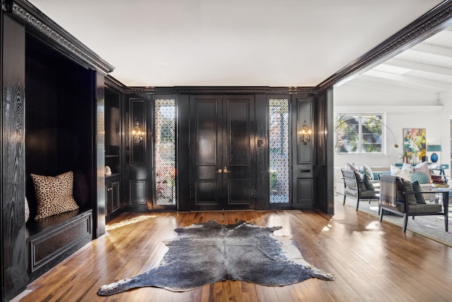 foyer featuring lofted ceiling with beams and light wood finished floors