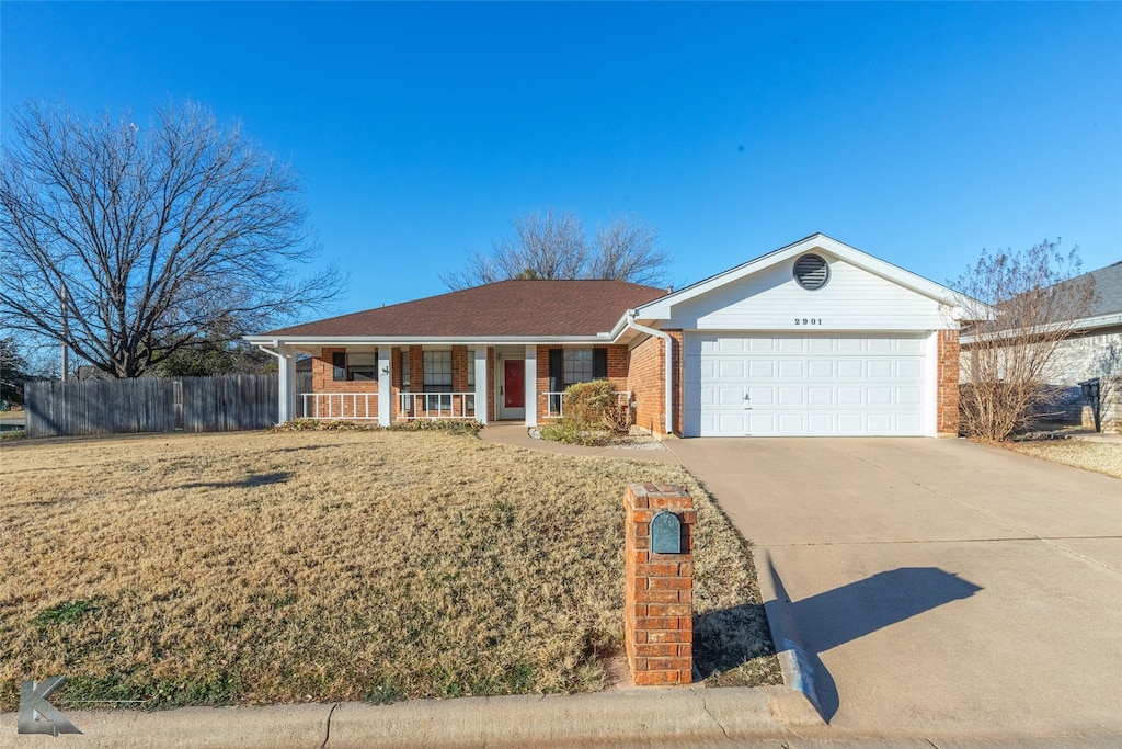 ranch-style house with a porch, a garage, and a front lawn