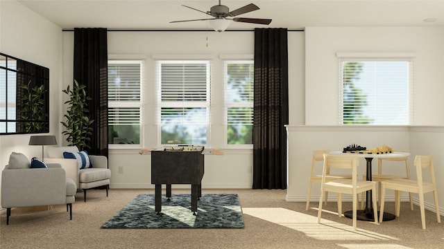 sitting room featuring a wealth of natural light, light carpet, and ceiling fan