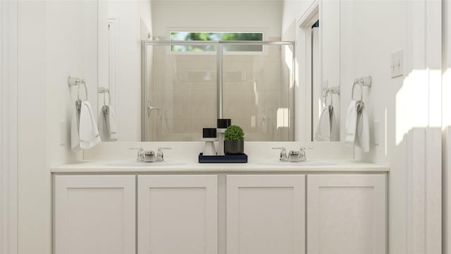 bathroom featuring a shower with door and vanity