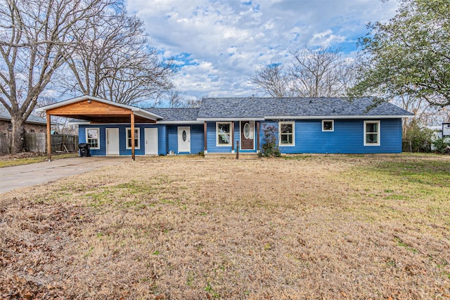 ranch-style home with a carport and a front lawn