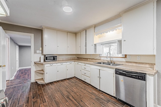 kitchen featuring stainless steel appliances, white cabinetry, sink, and ornamental molding