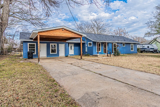 single story home featuring a front lawn and a carport