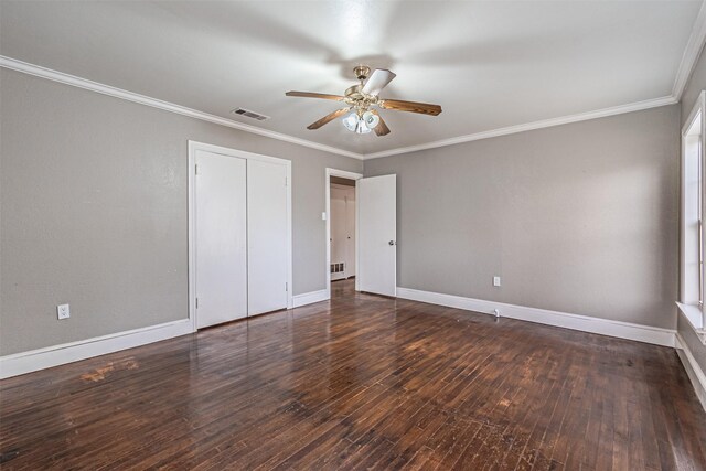 unfurnished bedroom featuring ceiling fan, ornamental molding, dark hardwood / wood-style flooring, and a closet