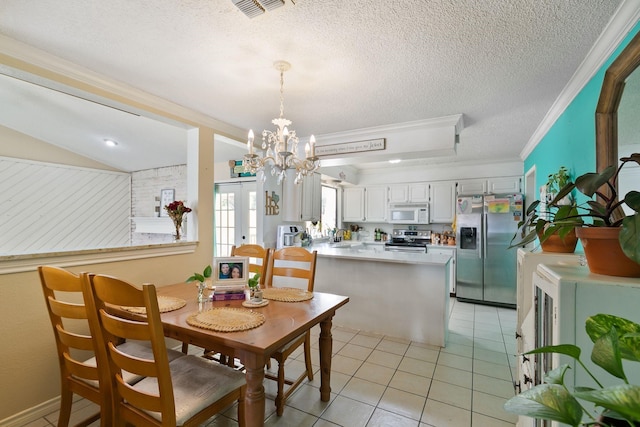 tiled dining area with sink, a chandelier, ornamental molding, a textured ceiling, and french doors