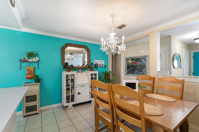 dining room with an inviting chandelier, crown molding, a textured ceiling, and light tile patterned flooring