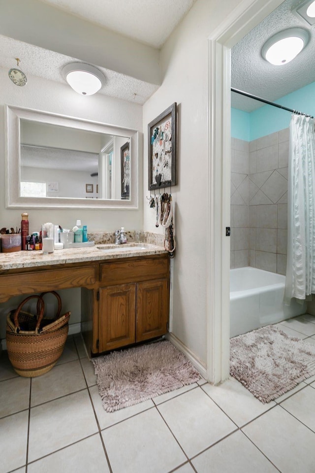 bathroom featuring tile patterned flooring, shower / bath combo, vanity, and a textured ceiling